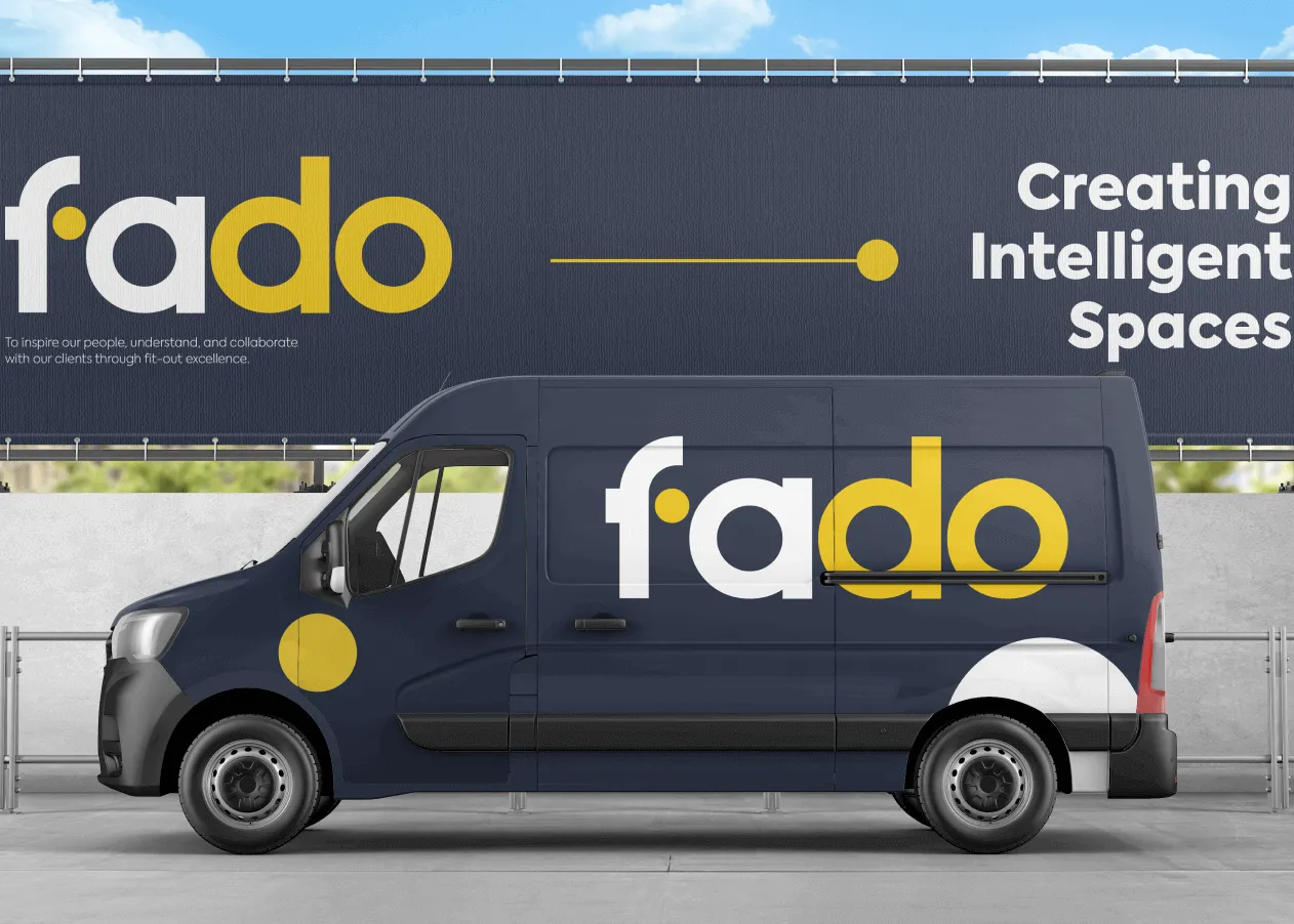 A navy Fado van parked in front of a Fado billboard reading Creating Intelligent Spaces
